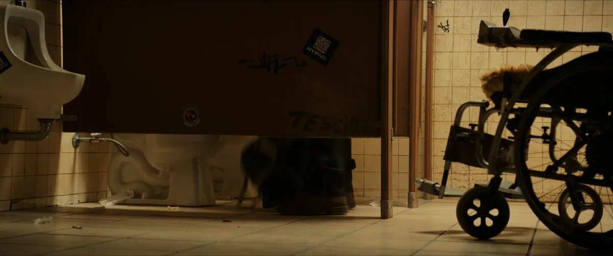 Screenshot of the Logan bathroom scene showing a QR code on the stall